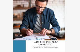 A man sitting at his desk, working on his cash flow analysis.